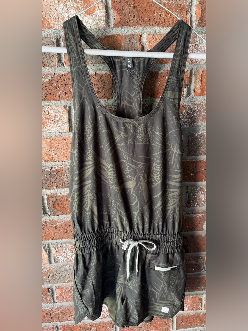 Vuori Clementine Racerback Romper in the tropical Oregano Rainforest pattern. Si
